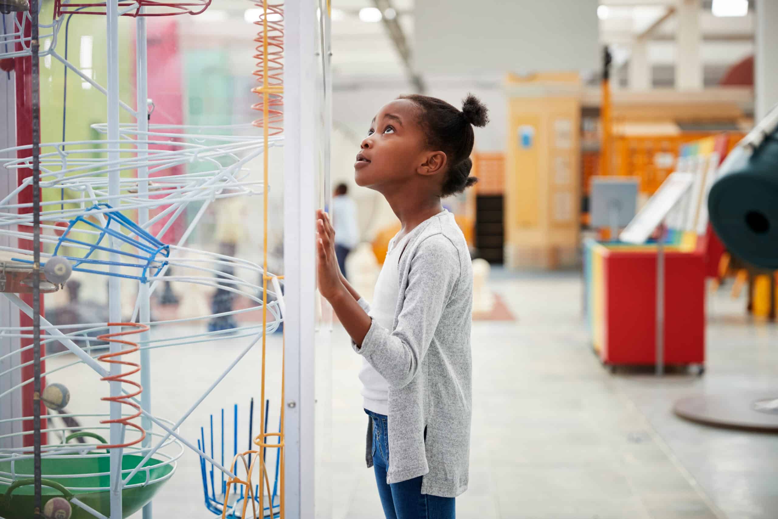 Girl examining a science exhibit