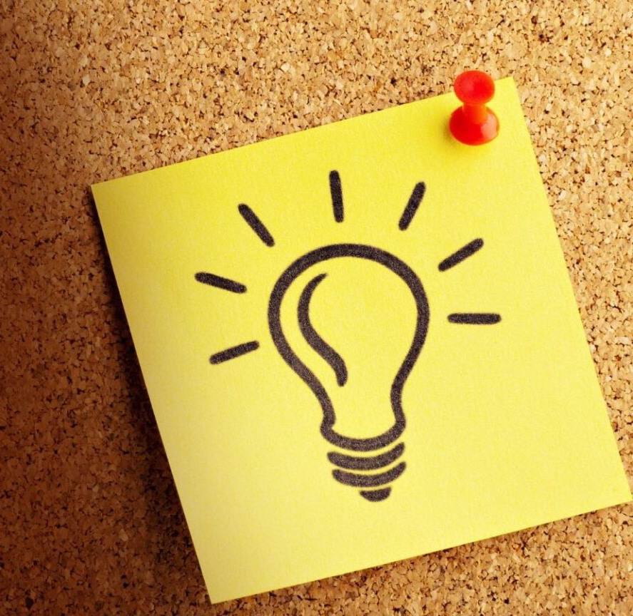 post it note of a lightbulb on cork board